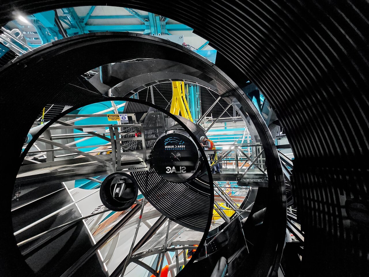 <p>The <a href="https://rubinobservatory.org/">NSF–DOE Vera C. Rubin Observatory</a> team installing the <a href="https://rubinobservatory.org/explore/how-rubin-works/technology/camera">LSST Camera</a> on the <a href="https://noirlab.edu/public/programs/vera-c-rubin-observatory/simonyi-survey-telescope/">Simonyi Survey Telescope</a> in March 2025.</p>